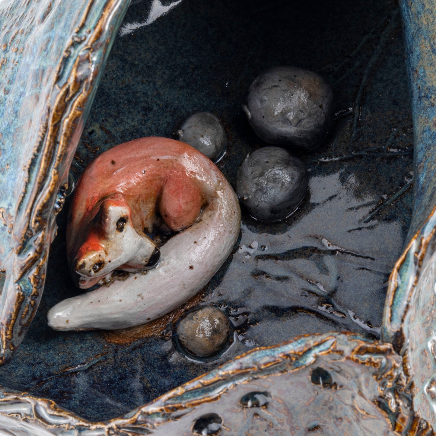 A Fox's Den Ceramic Triangular Sculpture