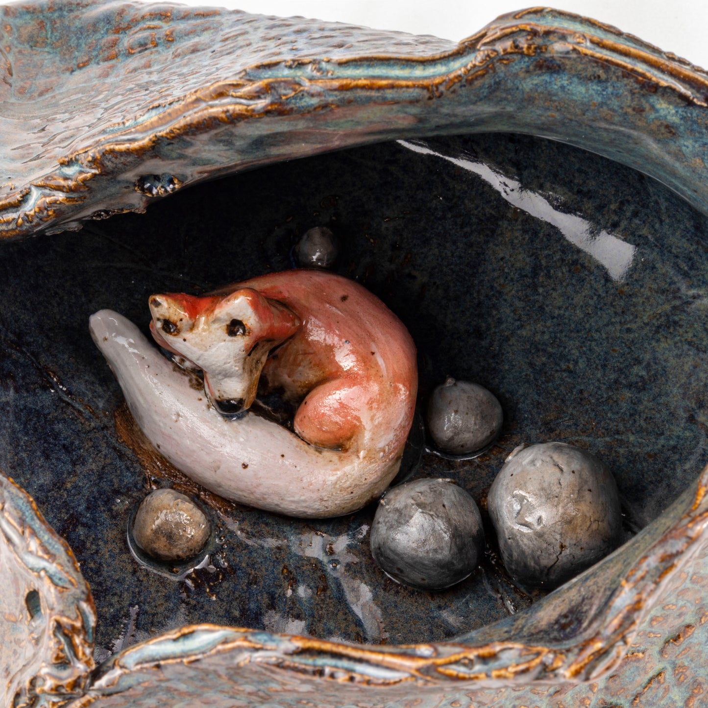 A Fox's Den Ceramic Triangular Sculpture